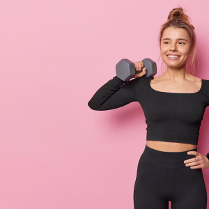 sporty-fit-young-woman-has-well-developed-muscles-by-strength-training-raises-dumbbell-has-training-